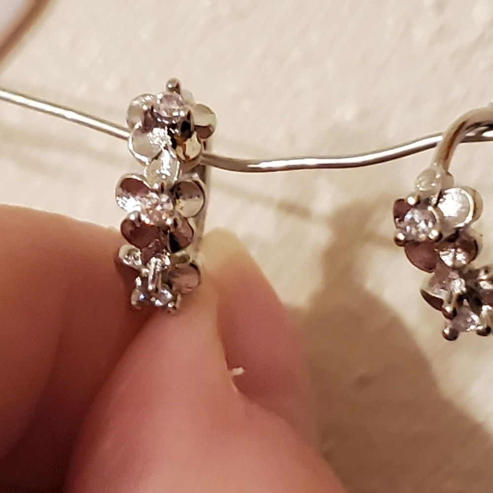 925 Sterling Silver Huggy Earrings With A Flower Motif.